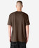 A unisex short sleeve T-shirt in brown, featuring a simple design and no visible logos on the back.