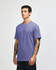 A unisex short sleeve t-shirt in a light purple hue, displayed on a model in a neutral background.