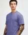 A unisex short sleeve T-shirt in a purple shade, featuring a subtle logo on the front.