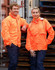 A pair of individuals wearing bright orange Hi Vis spray jackets, paired with navy trousers, against a backdrop of wooden pallets.