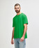 A green Gildan Softstyle adult T-shirt on a male model, paired with light denim jeans. The shirt has a logo.