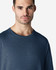 A navy blue Gildan Softstyle adult t-shirt on a male model, featuring a casual crew neck design and a plain backdrop.
