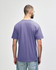 A midweight adult t-shirt in purple, featuring a simple design and a branding logo on the back.