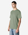 A midweight adult T-shirt in sage green, featuring a round neckline and short sleeves. It has a logo on the side.