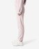 Unisex sweatpants in soft pink, featuring a snug fit and side pockets. Includes a visible logo detail.