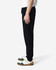 Unisex sweatpants in black with a drawstring waist, showcased on a model standing sideways.