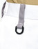 A close-up of white utility shorts featuring a grey belt loop and a black D-ring attachment.