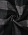 A close-up of black and grey flannel fabric featuring a plaid pattern, showcasing the texture and design.