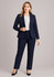 A navy women's suit jacket is displayed, paired with matching pants and a white blouse. The model wears black heels.