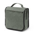 A green toiletry bag with a top handle, featuring a zippered pocket and a textured fabric design.