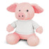 A pink pig plush toy with a soft texture and dressed in a white shirt sits upright. It has a friendly expression and rounded features.