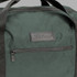 A green duffle bag with a front zip pocket and a branding logo.