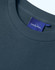 A close-up of a navy unisex crew neck sweater featuring a ribbed neckline and a small logo tag.