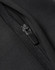 A close-up of a black softshell jacket featuring a zipper detail and a textured fabric finish.