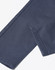 A close-up of navy blue flexi chino pants showing the stitching and hem details, including a logo.