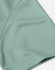 A close-up of a mint green jacquard knit fabric, showcasing its texture and pattern detail.