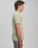 A light green men's premium cotton short-sleeve t-shirt displayed on a model from the side. The shirt has a logo.