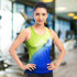 A women's sports singlet in green and blue with a logo, set in a gym environment.