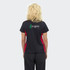 A women's polo shirt in black with red accents and a logo on the back.