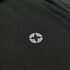 A close-up of a black polo shirt featuring a logo on the chest area.