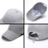 A grey heavy acrylic cap featuring a curved brim, six panels, and an adjustable strap at the back.