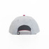 A grey cap with a contrasting pink button on top and an adjustable strap at the back. Features a logo.