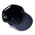 A navy cap with a structured brim and an interior lining, featuring branding inside.