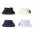 Four bucket hats in black, cream, navy, and light blue, each with a logo tag attached.