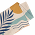 A sandless beach towel with a design featuring a yellow sun, blue waves, and green leaves in pastel colours.