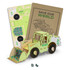 A wooden model of a wheel loader in light green, accompanied by cardboard sheets for assembly and instructions.