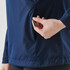 A hand adjusts the zipper of a navy blue Women's Pacifica 1/4 Zip Anorak, featuring a side pocket.