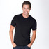 A black tri-blend crew t-shirt featured on a smiling man, with a simple design and a logo present.
