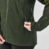 A green women's jacket with zipped pockets, featuring a high collar and a snug fit. It has a logo on the arm.