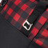 A cooler bag featuring a red and black checkered pattern, with a sturdy strap and metal buckle detail.