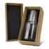 A glass carafe and tumbler set in a brown box with black interior padding. The glass is clear and sleek.