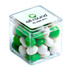 A clear cube containing chewy fruit confectionery in green and white hues, with a logo on the top.