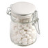 A glass clip lock jar filled with white mints, featuring a metal clasp and a white lid.