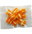 A clear bag containing orange and white striped humbug candies.