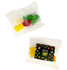 Mixed lollies in a clear bag, featuring yellow, red, green, and white gummy candies. Packaging includes a logo.