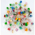 A collection of individually wrapped rock candy pieces in various vibrant colours, including green, pink, yellow, and blue.