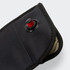 A lockable phone pouch in black with a red button and a textured interior. Features a zippered closure.