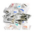 Assorted packs of white mints in shiny silver and clear packaging, featuring various logos and branding.