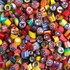 A vibrant assortment of personalised rock candy pieces in various colours and designs, with a mix of patterns.