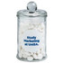 A clear apothecary jar containing white chewy mints, topped with a round lid and featuring a logo.