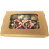 A kraft gift box containing assorted sweets, including candy canes and various festive confections.