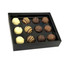 A black box containing twelve assorted chocolate truffles in various flavours, including white and dark chocolate.