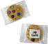 A cookie featuring colourful chocolate buttons, wrapped in clear packaging with a logo.