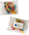 A clear packet containing assorted sour gummy worms in vibrant colours: red, yellow, green, and blue.