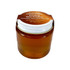 A glass jar filled with amber honey, featuring a lid and a logo. The jar is reusable and recyclable.