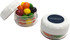 A small screw cap jar contains colourful Skittles in red, orange, yellow, green, and black, with a logo on the lid.